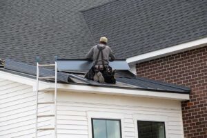 Roofing technicians inspect layered materials, flashing, solar shingles, and attic ventilation on a residential roof.