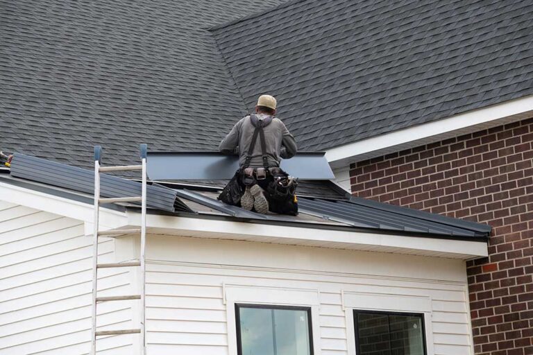 Roofing technicians inspect layered materials, flashing, solar shingles, and attic ventilation on a residential roof.